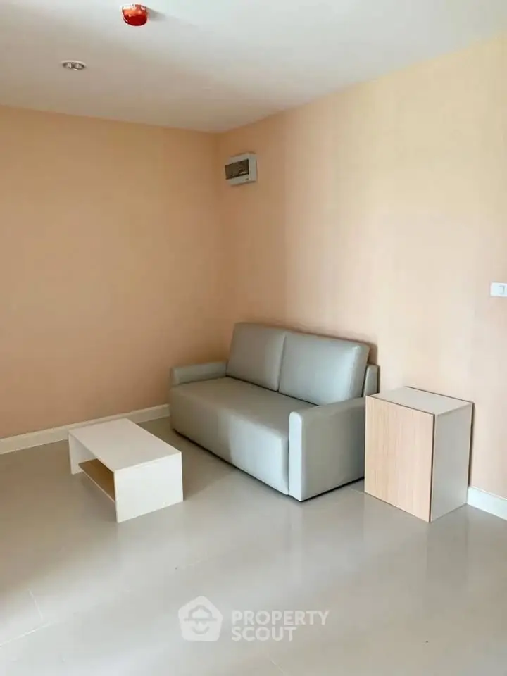 Minimalist living room with modern sofa and coffee table in a cozy apartment.