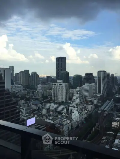Stunning cityscape view from a high-rise balcony showcasing urban skyline and architectural diversity.