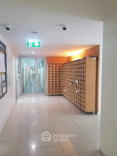 Modern apartment building hallway with mailboxes and secure entry