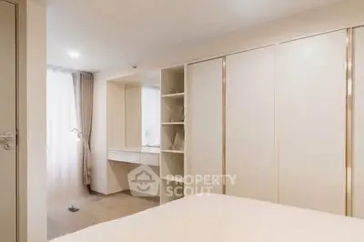 Spacious bedroom with built-in wardrobe and natural light