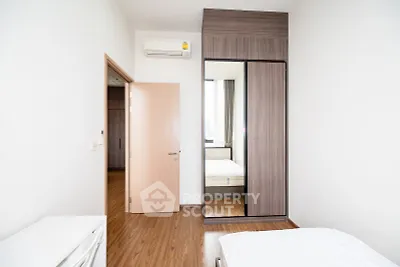 Modern bedroom with wooden flooring and built-in wardrobe