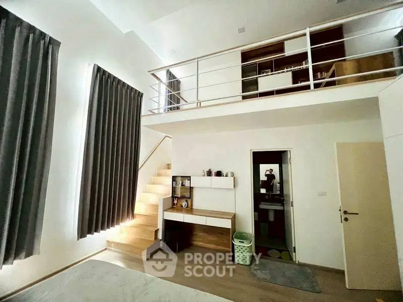 Modern loft-style bedroom with mezzanine and sleek design