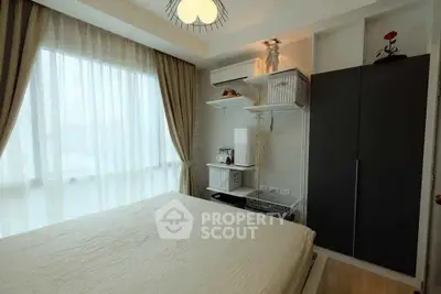 Modern bedroom with large window, stylish decor, and ample storage space.