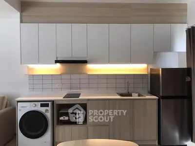 Modern kitchen with sleek cabinetry, built-in appliances, and under-cabinet lighting.