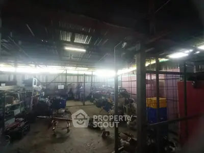 Spacious industrial storage unit with ample shelving and equipment.