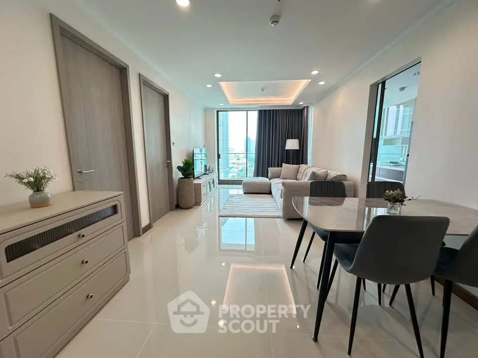 Modern living room with sleek furniture and large windows offering a stunning view.