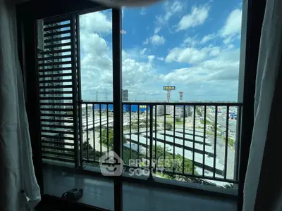Stunning balcony view with cityscape and IKEA in the distance, perfect for urban living.