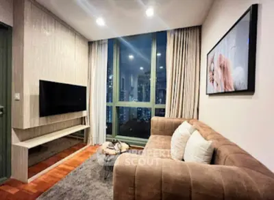 Modern living room with large window and stylish decor in urban apartment.