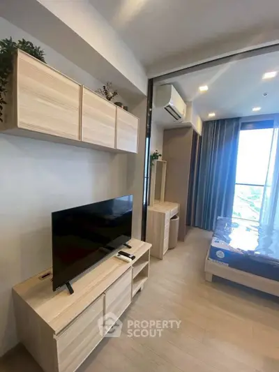 Modern apartment interior with sleek wooden furniture and large window view