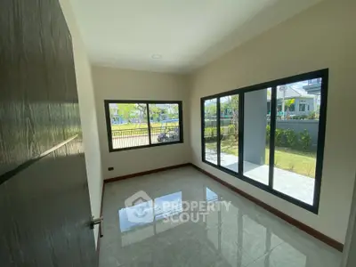 Bright empty room with large windows and garden view