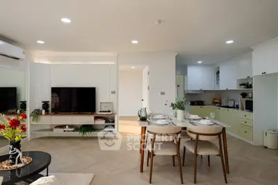 Modern open-plan living room and kitchen with stylish decor and dining area