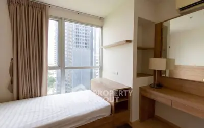 Modern bedroom with large window and wooden furniture in urban apartment