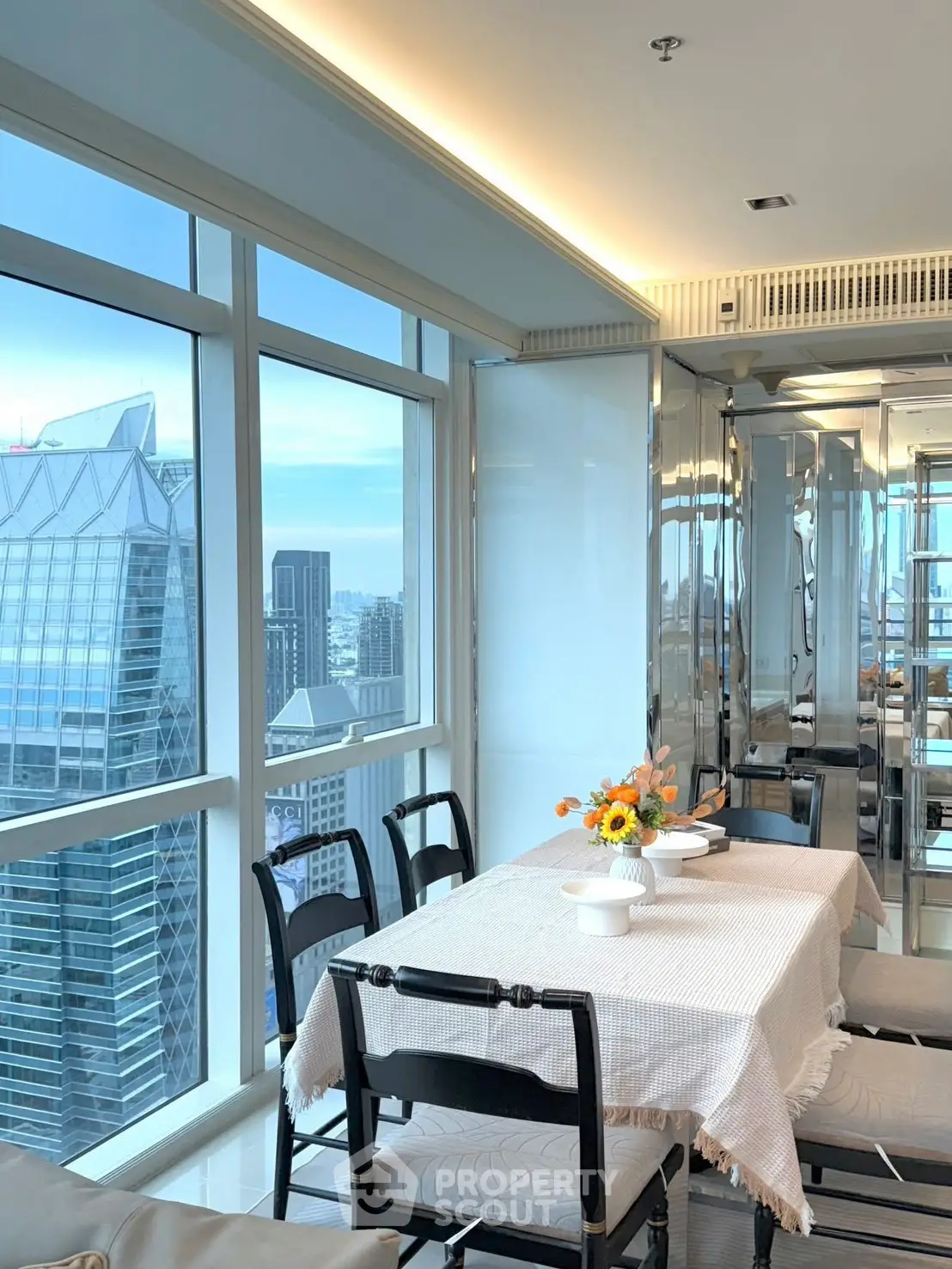 Luxurious dining area with stunning city view in modern high-rise apartment