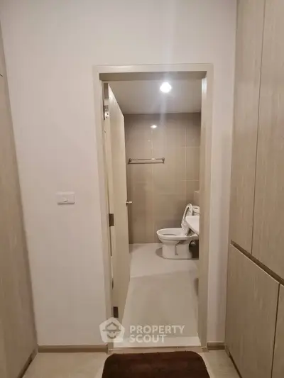 Modern bathroom entrance with sleek design and neutral tones