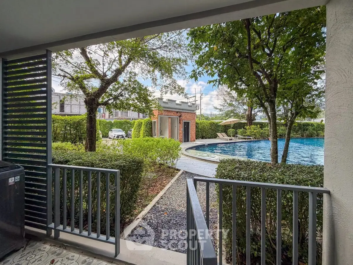 Luxurious poolside view with lush greenery and serene ambiance in a modern residential complex.