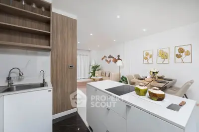 Modern open-layout kitchen and living room with stylish decor and dining area