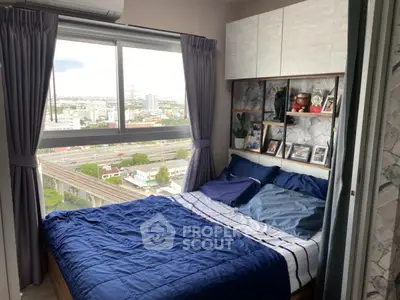 Cozy bedroom with large window offering stunning city view and modern decor