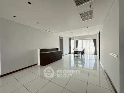 Spacious modern living room with sleek tile flooring and elegant dining area.