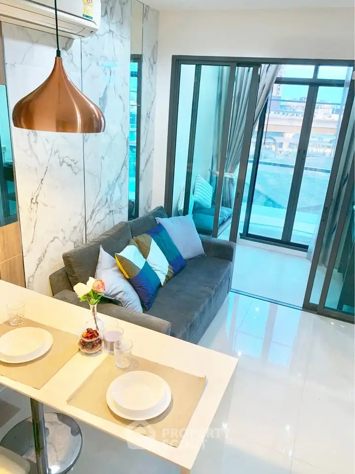 Modern living room with stylish decor and large windows offering a stunning view.