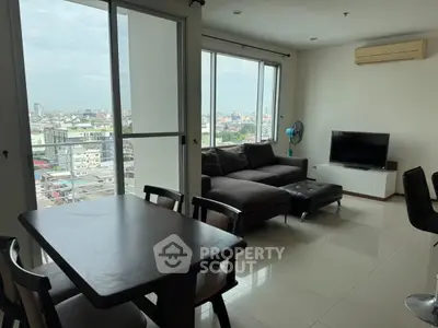 Modern living room with city view, featuring sleek furniture and large windows.