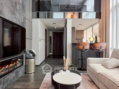 Modern living room with sleek design, featuring a cozy fireplace, stylish bar stools, and elegant decor.