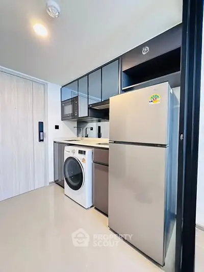 Modern kitchen with sleek appliances and ample storage space
