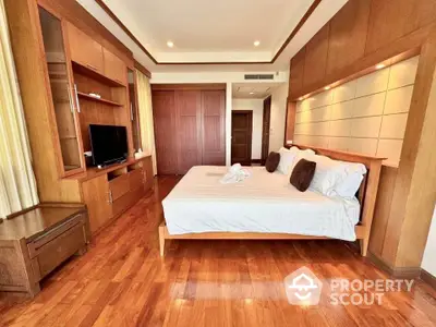 Luxurious bedroom with wooden flooring and modern furnishings in elegant apartment