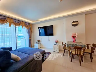 Spacious living room with modern decor and large window view