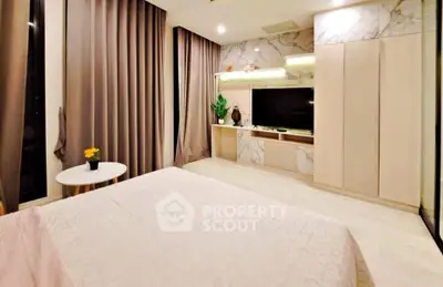 Luxurious bedroom with elegant decor and modern entertainment center