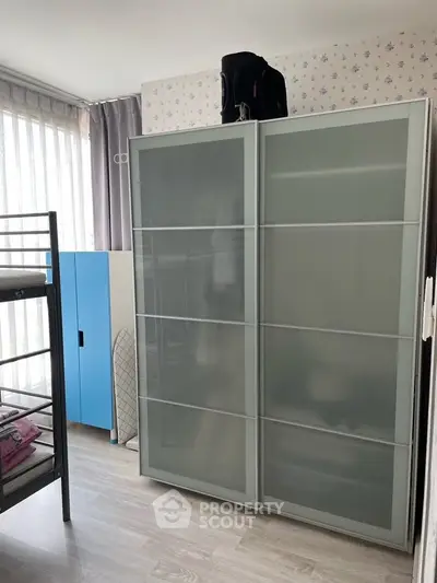 Modern bedroom with sliding wardrobe and bunk bed, perfect for maximizing space.