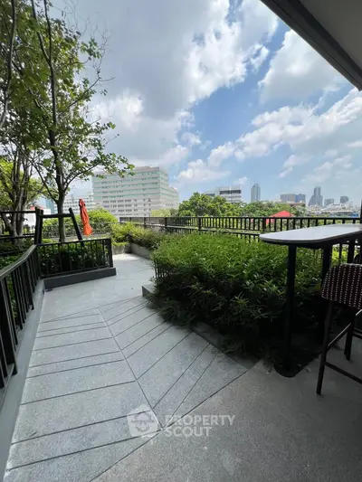 Stunning balcony with lush greenery and city skyline view, perfect for relaxation and outdoor enjoyment.