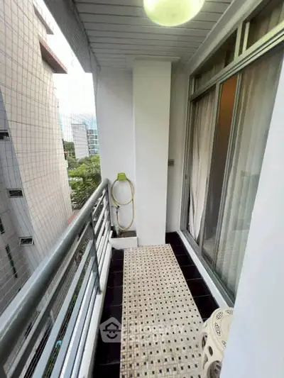 Charming city balcony with safety netting and modern railing, perfect for urban relaxation.