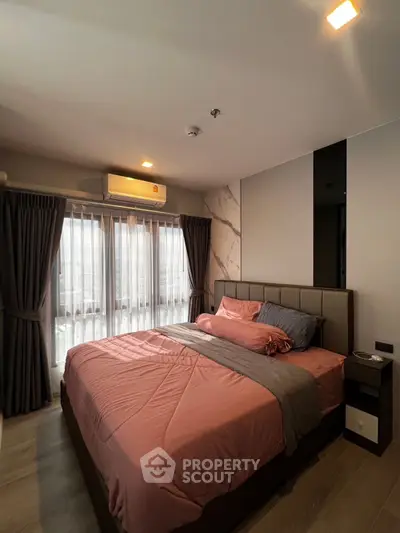 Modern bedroom with stylish decor and large window for natural light