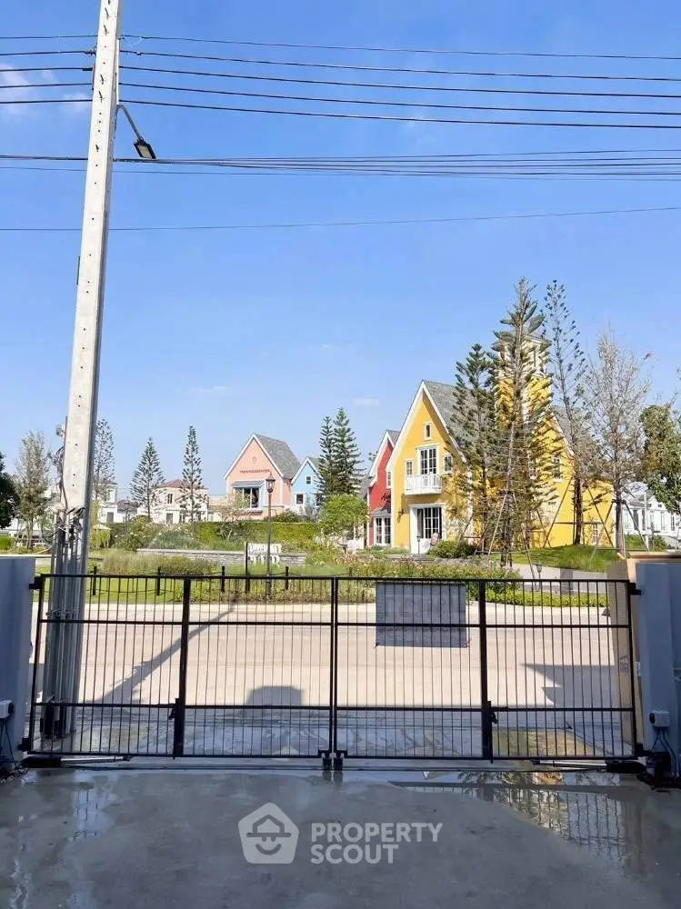 Charming suburban homes with colorful facades and lush greenery in a serene neighborhood.