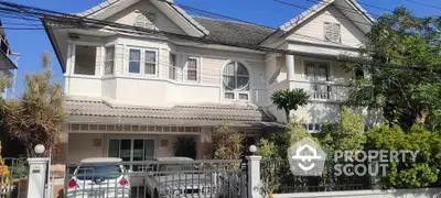 Charming two-story family home with a welcoming facade, featuring a spacious balcony and lush greenery, nestled in a serene neighborhood.