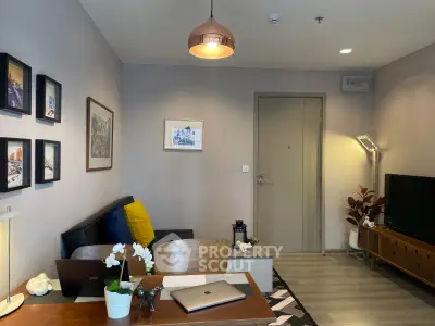 Modern living room with stylish decor and cozy ambiance, featuring a sleek TV setup and elegant lighting.