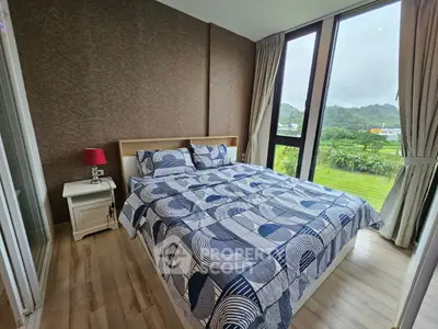 Modern bedroom with large windows and scenic view