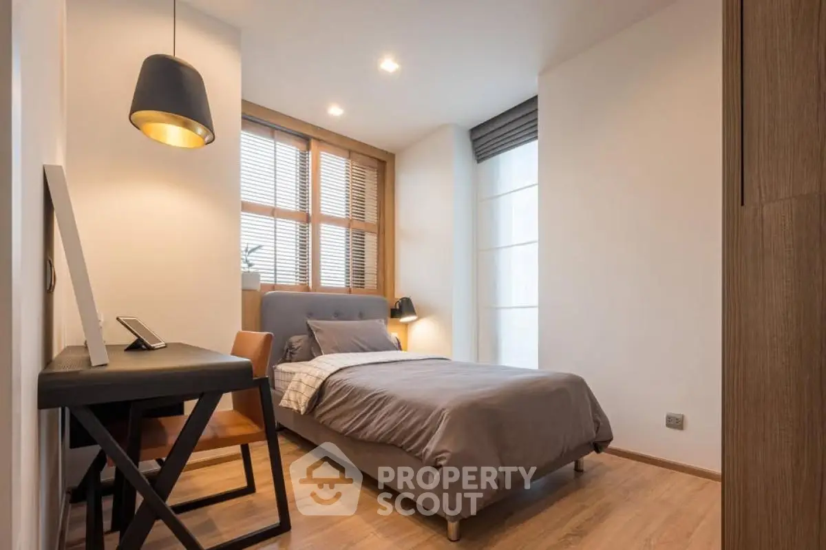 Modern bedroom with stylish decor and natural light