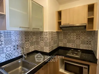 Modern kitchen with stylish backsplash and built-in appliances