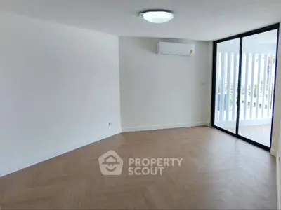 Spacious modern living room with large windows and air conditioning