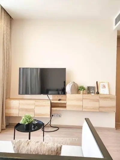 Modern living room with wall-mounted TV and stylish wooden cabinets