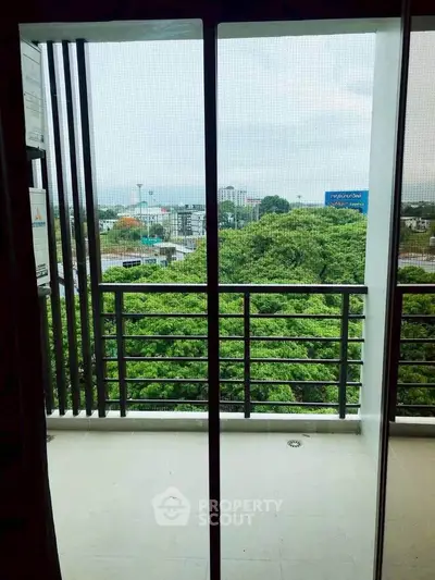 Spacious balcony with lush green view in modern apartment