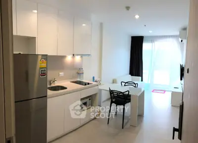 Modern open-plan kitchen and living area with sleek design and natural light.
