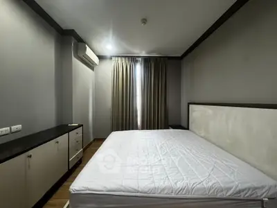 Spacious bedroom with modern decor and ample natural light