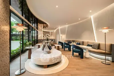 Luxurious modern living room with elegant curved seating and stylish lighting, perfect for relaxation and entertaining.