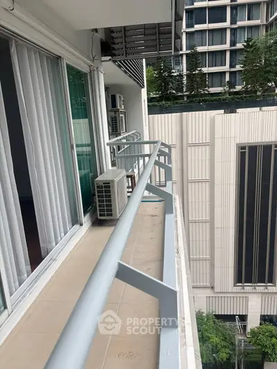 Spacious balcony with city view in modern apartment building