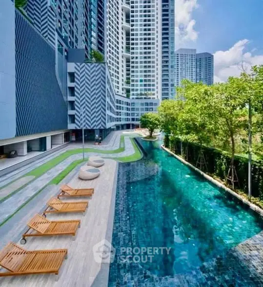 Luxurious modern apartment complex with stunning pool and lush greenery