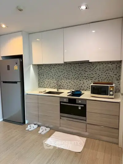 Modern kitchen with sleek cabinetry and built-in appliances