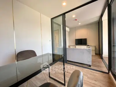 Modern living room with glass partition and sleek furniture design