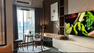 Modern living room with large TV, stylish decor, and city view window.